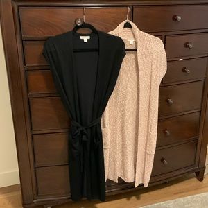 Two long sleeveless sweaters with front pockets